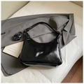 Glossy black underarm bag with knot strap and detachable crossbody strap on grey blazer - Black (Without Charm)