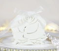 Close-up of laser-cut rose hollow paper gift box with white satin ribbon detail - Ivory