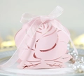 Detail of pink laser-cut rose candy box with shimmering pearl paper and white ribbon bow - Pink
