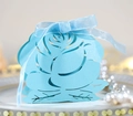 Detail of laser-cut rose hollow candy box in sky blue with elegant silk ribbon bow - Tiffany Blue