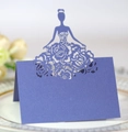 Macro shot of navy blue laser-cut place card with elegant floral silhouette detail - Sapphire Blue