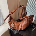 Brown faux leather half-moon shoulder bag with knotted strap and plush charm - Brown