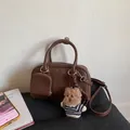 Vintage brown leather bowling bag with plush bear charm and detachable strap on black cushion - With Charm / Brown