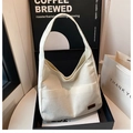 Detail of cream corduroy tote bag showing soft ribbed texture and brown leather logo tag - White