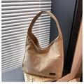 Detail of corduroy tote bag featuring a leather patch and textured fabric finish - Khaki