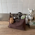 Retro dark brown matte leather hobo bag with teddy bear charm on wooden surface - Brown