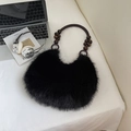 Fuzzy black faux fur shoulder bag with brown wooden beaded handle in a cozy lifestyle setup - Black