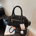Black bowling handbag with adjustable side straps and a transparent ID card tag - Black