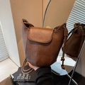 Vintage brown leather bucket bag with vertical stitching and knotted shoulder strap - Brown