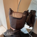 Minimalist dark brown leather bucket bag with flap closure and drawstring shoulder strap - Coffee