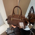 Vintage brown leather bowling bag with top handles, crossbody strap and dog charm - Brown