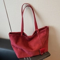 Deep red suede tote bag with slim shoulder strap and decorative metallic pendant - Red
