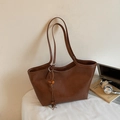 Retro brown leather tote bag with elegant tassel detail for daily office commute - With Charm / Brown