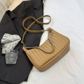 Chic tan woven crossbody bag with metal chain handle and leather strap in lifestyle setting - Small / Khaki