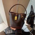Vintage dark brown matte leather bucket bag with top handle and gold metal lock - Coffee