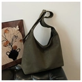 Detailed close-up of dark olive green suede tote bag with adjustable gold buckle and wide strap - Green