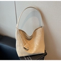 Detail of minimalist beige suede tote bag with knot strap and mini coin pouch accessory - Khaki