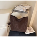 Detail view of large dark coffee tote bag with vintage matte texture and side knot - Coffee