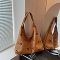 Brown suede hobo tote bag featuring laser-cut floral patterns and a minimalist design - Brown