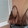 Dark brown suede underarm bag with decorative hollowed floral patterns and curved strap - Brown