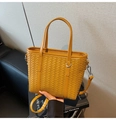 Detail of yellow woven PU leather bucket bag featuring silver hardware and crossbody strap - Yellow Brown
