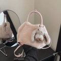 Fuzzy faux fur handbag in light pink featuring a cute plush bunny charm and round handles - Pink with Pendant