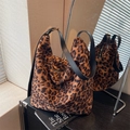 Retro leopard print bucket bag with black leather strap and gold metal buckle detail - Tan
