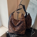 Hobo shoulder bag with leopard print and black adjustable leather strap in stylish setting - Dark Brown
