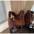 Detail view of large dark brown suede tote bag with teddy charm and adjustable strap - With Pendant / Coffee
