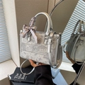 Silver-grey embroidered tote bag with floral patterns, circular handles and a purple scarf - Silver