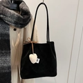 Faux suede black bucket bag featuring a soft white plush heart charm and logo tag - Black with Pendant