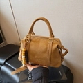 Brown suede Boston bag with vintage gold hardware and a colorful beaded pendant charm - Brown