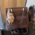 Chocolate brown suede backpack with woven straps and a cute plush dog pendant charm - Coffee with Pendant