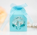 Macro shot of laser-cut Merry Christmas tree pattern on light blue paper gift box with ribbon - Tiffany Blue