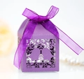 Close-up of purple laser-cut candy box with bell patterns and a satin ribbon bow - Dark Purple