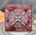 Macro view of laser-cut burgundy rose wedding invitation with elegant floral details - Dark Red
