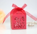 Detail view of red laser-cut candy box with floral patterns and a matching organza ribbon - Pearlescent Red