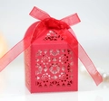 Detail view of red laser-cut floral wedding favor box with a delicate organza ribbon bow - Pearlescent Red