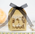Detail of laser-cut bell pattern on kraft paper gift box with black ribbon bow - Kraft Paper