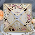 Detailed laser-cut gold rose wedding invitation cover on an elegant ceramic plate - Beige Gold