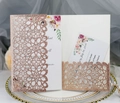 Close-up of rose gold glitter laser-cut floral wedding invitation with inner cards - Apple Gold