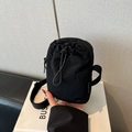 Minimalist black nylon crossbody phone bag with drawstring and adjustable shoulder strap - Black