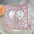 Rose gold glitter wedding invitation with laser cut heart and couple silhouette - Pink