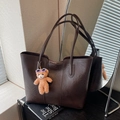 Retro dark brown tote bag in oil wax texture with cute teddy bear charm and sleek straps - Brown
