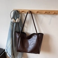 Minimalist large dark brown tote bag in glossy PU leather hanging on wooden hook - Coffee No Charm