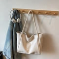Minimalist cream white large tote bag in soft faux leather hanging on a wooden rack - Off-white Without Pendant