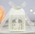 Close-up of laser-cut white ballerina favor box with elegant silver ribbon bow - Ivory