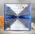 Detail of laser-cut wedding invitation with navy lace sleeve and floral inner card - Magic Blue