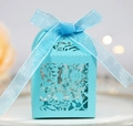 Detail of light blue laser-cut floral wedding favor box with an elegant ribbon bow - Turquoise Blue