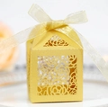 Close-up of golden laser-cut rose gift box with elegant ribbon for wedding favors - Gold